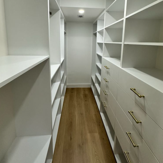 Custom walk-in closet renovation in Fort Lauderdale with built-in shelving and storage