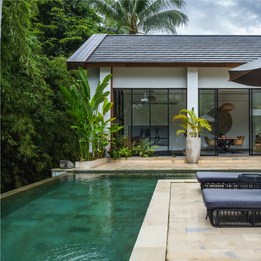 luxury-outdoor-living-space-featuring-a-modern-pool-deck-and-stone-patio-completed-by-a-professional-general-contractor-miami-fl